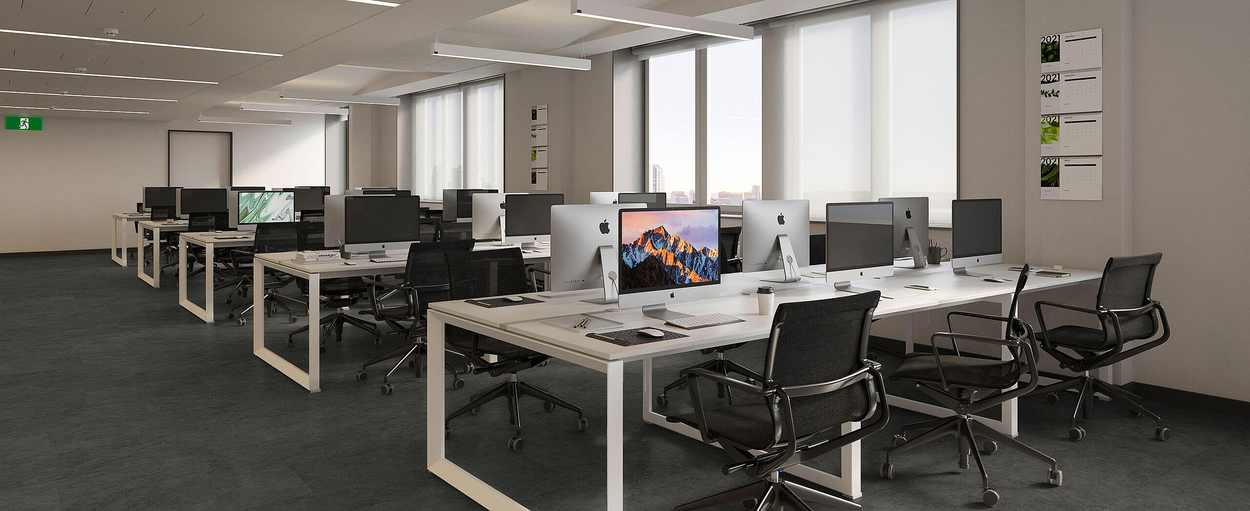 Bright workspace with desk rows and recycled elastic flooring in a calm anthracite design. Modern open-plan office with recycled elastic flooring in a dark, subtly textured look.