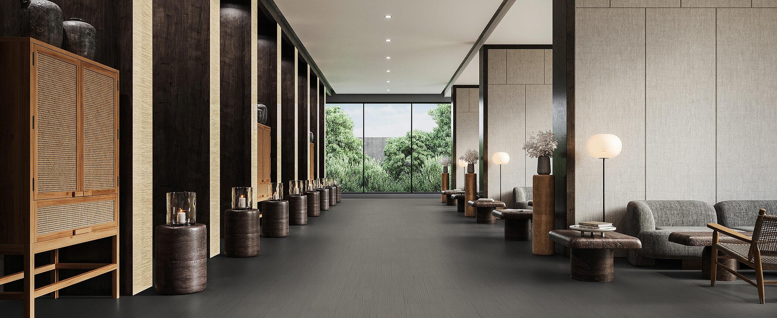 Elegant lounge corridor with recycled elastic flooring in a dark, finely textured stone look.