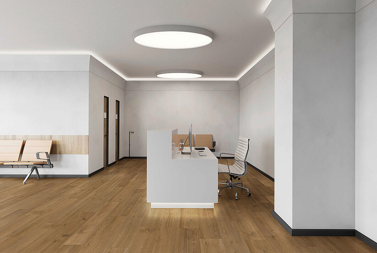 Modern reception area with recycled elastic flooring in warm wood-look.
