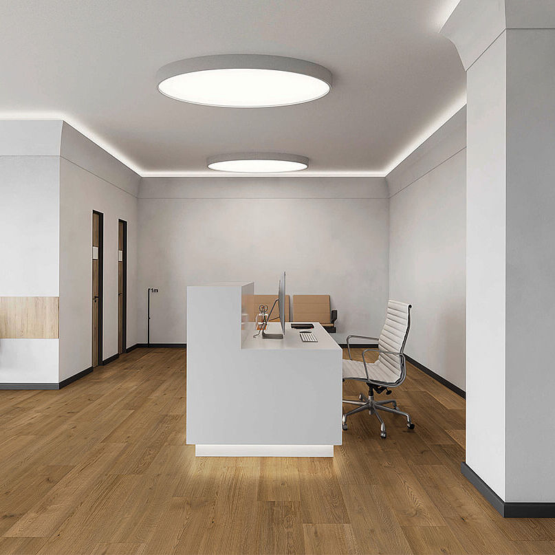Modern reception area with recycled elastic flooring in warm wood-look.