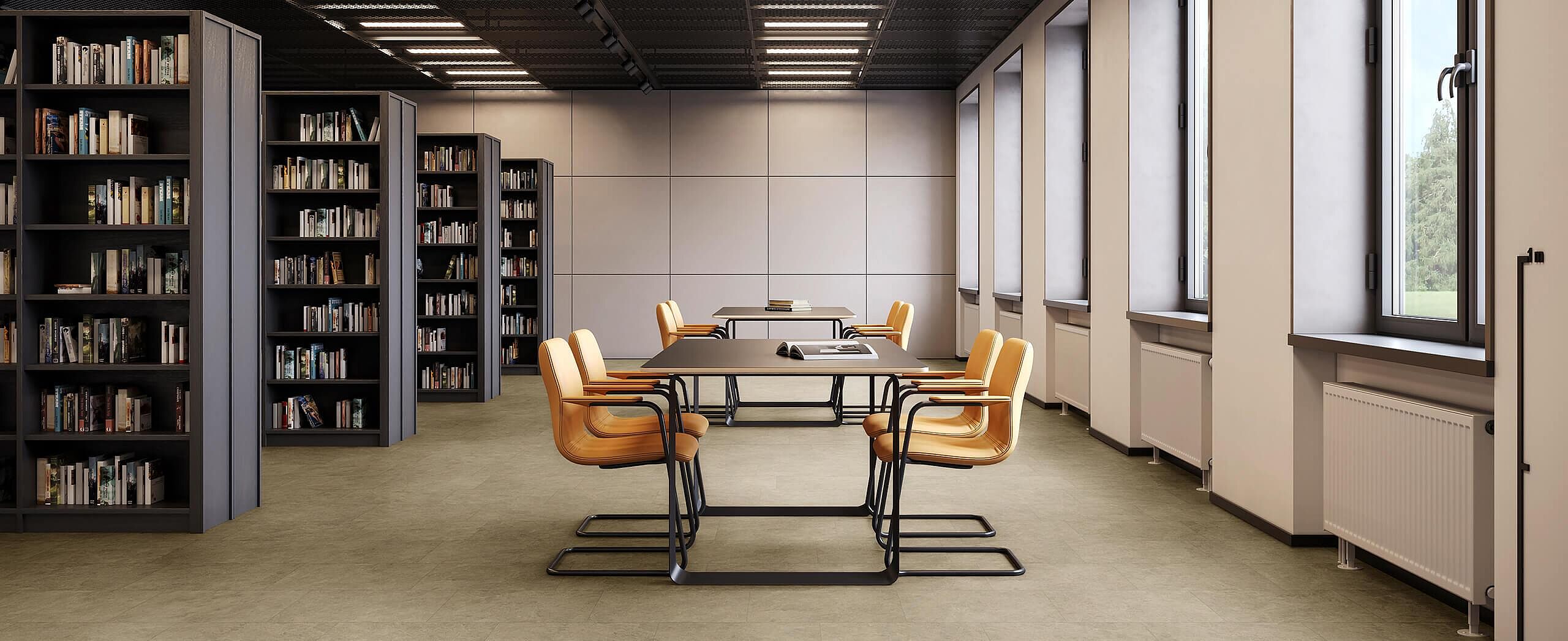 Library room with shelves and tables, yellow chairs on recycled elastic flooring in a light sand-stone look.